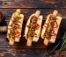 Loaded-Hot-Dogs-with-Bacon,-Onions,-and-Pickled-Cucumbers